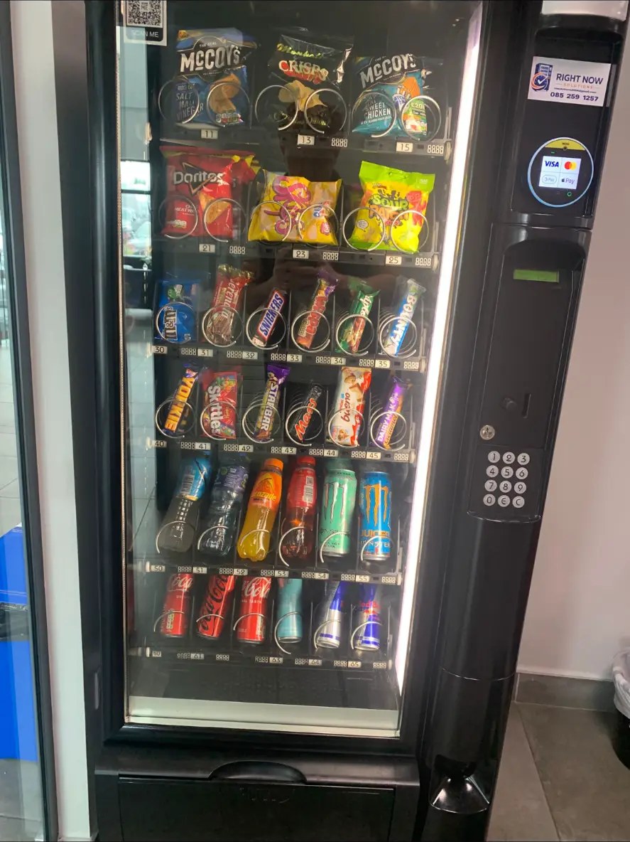 Right Now Solutions vending machine stocked with crisps, chocolate and cold drinks in a waiting area